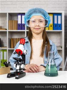 girl with hair net safety glasses doing science experiments