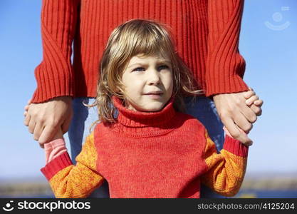 girl with hands of father, selective focus on eyes