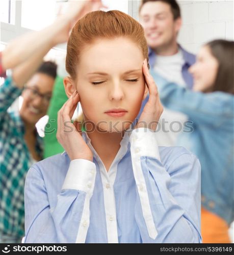 girl with headache holding her head with hands at school