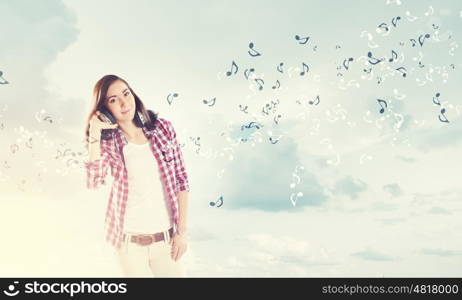 Girl with headphones. Young pretty girl in casual wearing headphones