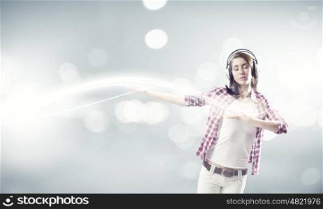 Girl with headphones. Young pretty girl in casual wearing headphones