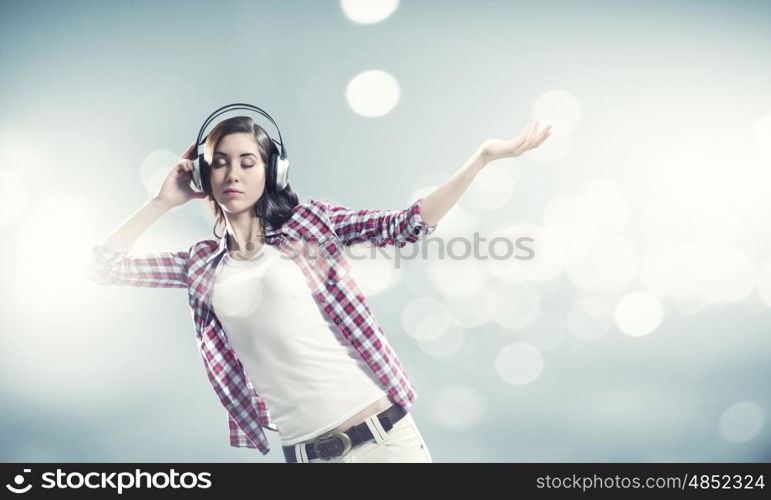 Girl with headphones. Young pretty girl in casual wearing headphones