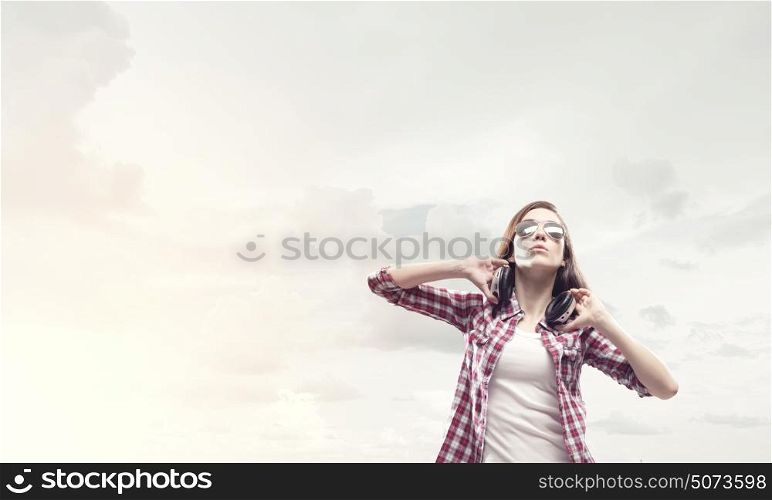 Girl with headphones. Young pretty girl in casual wearing headphones