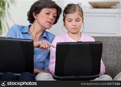 Girl with her grandmother and laptop computers