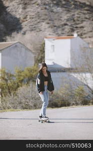 Girl with her skate on a town road