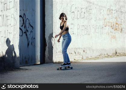 Girl with her skate on a town road