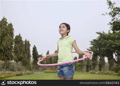 Girl with hoola hoop playing outdoors