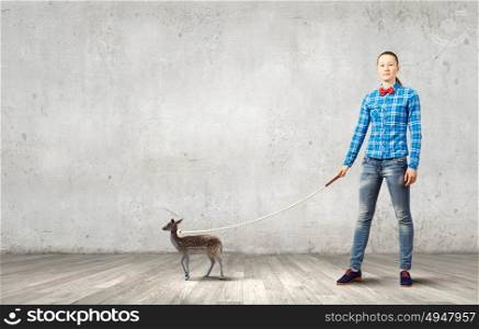 Girl with kangaroo. Young woman in casual holding deer on lead