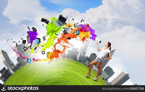 Girl with megaphone. Young teenager girl in shorts screaming in megaphone