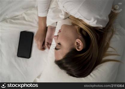 girl with mobile while sleeping