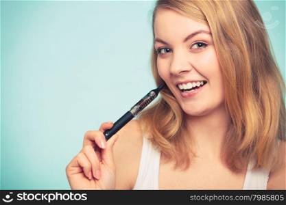 Girl with normal and electronic cigarette.. Pretty girl smoking electronic cigarette. Addicted nicotine problems in young age. Addiction concept with copy space.