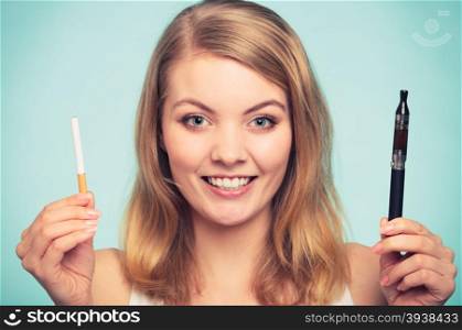 Girl with normal and electronic cigarette.. Pretty girl smoking normal and electronic cigarette. Addicted nicotine problems in young age. Addiction concept.
