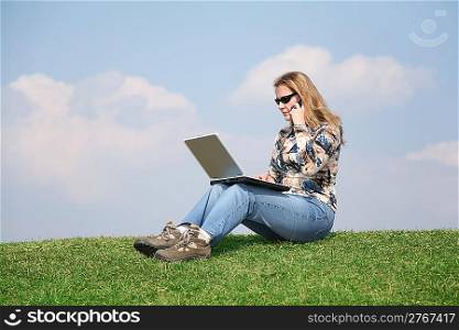 girl with notebook and phone on grass
