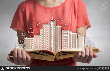 Girl with opened red book. Close view of woman holding opened book and construction concept on pages