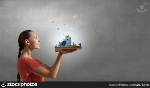 Girl with opened red book. young woman holding opened book and construction concept on pages