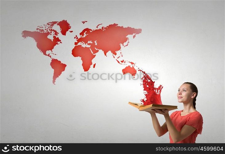 Girl with opened red book. Young woman in red dress with opened book in hand