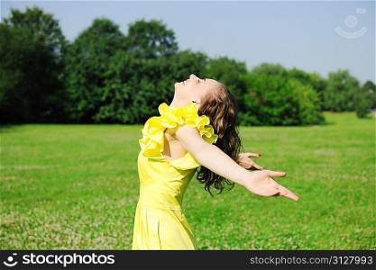 Girl with outstretched arms outdoors