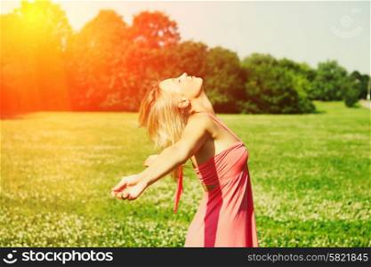 Girl with outstretched arms outdoors