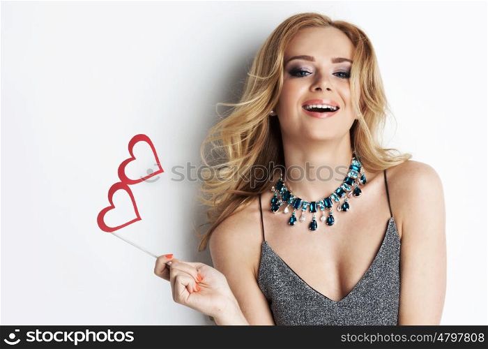 Girl with party heart glasses. Happy laughing girl with party heart shaped paper glasses on stick