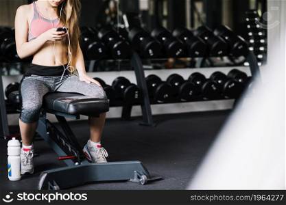 girl with phone sitting gym. High resolution photo. girl with phone sitting gym. High quality photo
