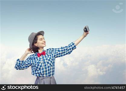 Girl with photo camera. Young beautiful woman making selfie photo with retro camera