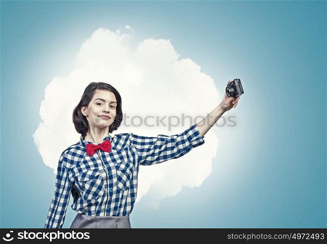 Girl with photo camera. Young beautiful woman making selfie photo with retro camera