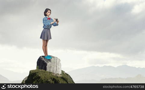 Girl with photo camera. Young beautiful woman taking photo with retro camera