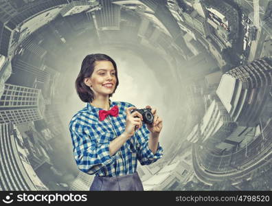 Girl with photo camera. Young beautiful woman taking photo with retro camera