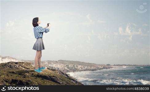Girl with photo camera. Young beautiful woman taking photo with retro camera