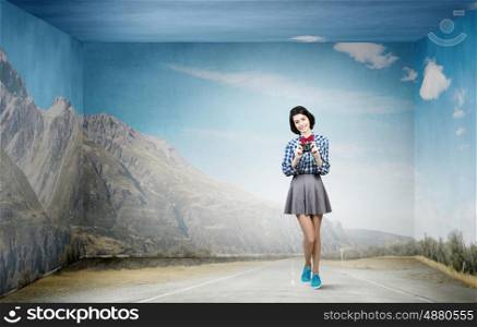 Girl with photo camera. Young beautiful woman taking photo with retro camera
