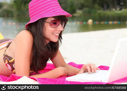 Girl with pink hat and computer