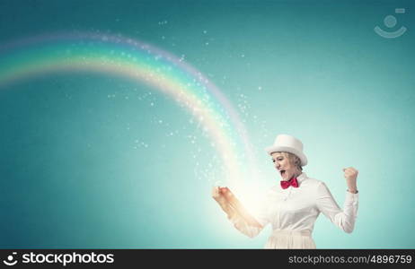 Girl with red book. Young emotional woman in white cylinder with book in hand