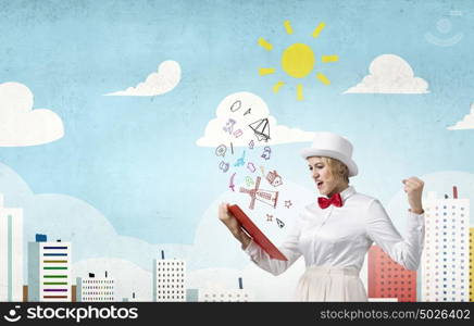 Girl with red book. Young emotional woman in white cylinder with book in hand