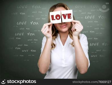 Girl with romantic thoughts, holding in hands greeting cards, congratulation with Valentine day, happy holiday for lovers
