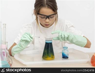 girl with safety glasses doing chemistry experiments test tubes