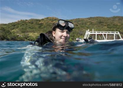 Girl with scuba gear with her head above water, Ixtapa, Guerrero, Mexico