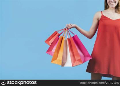 girl with shopping bags plain background
