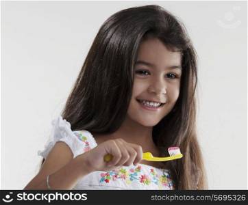 Girl with toothbrush and toothpaste