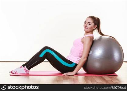 Girl with training equipment. Young female in gym with fit ball. Activity fitness health workout concept.. Girl with training equipment.