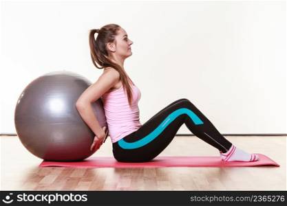 Girl with training equipment. Young femalein gym with fit ball. Activity fitness health workout concept.. Girl with training equipment.