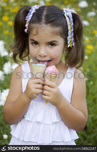 Girl with two portion of ice cream with satisfied little face