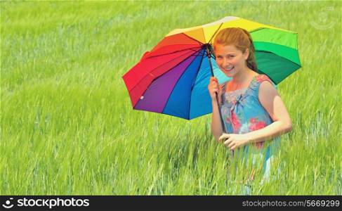 girl with umbrella on field in summer time