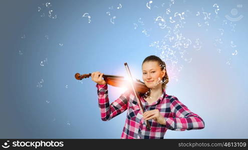 Girl with violin. Young pretty girl in casual playing violin