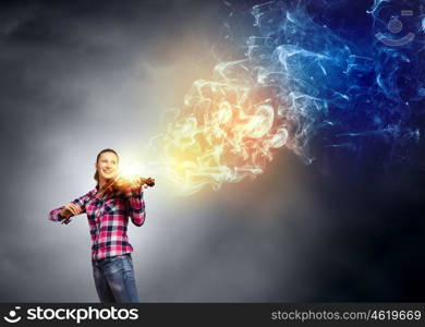 Girl with violin. Young pretty girl in casual playing violin