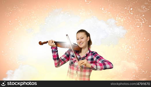 Girl with violin. Young pretty girl in casual playing violin