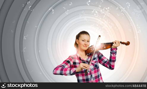 Girl with violin. Young pretty girl in casual playing violin