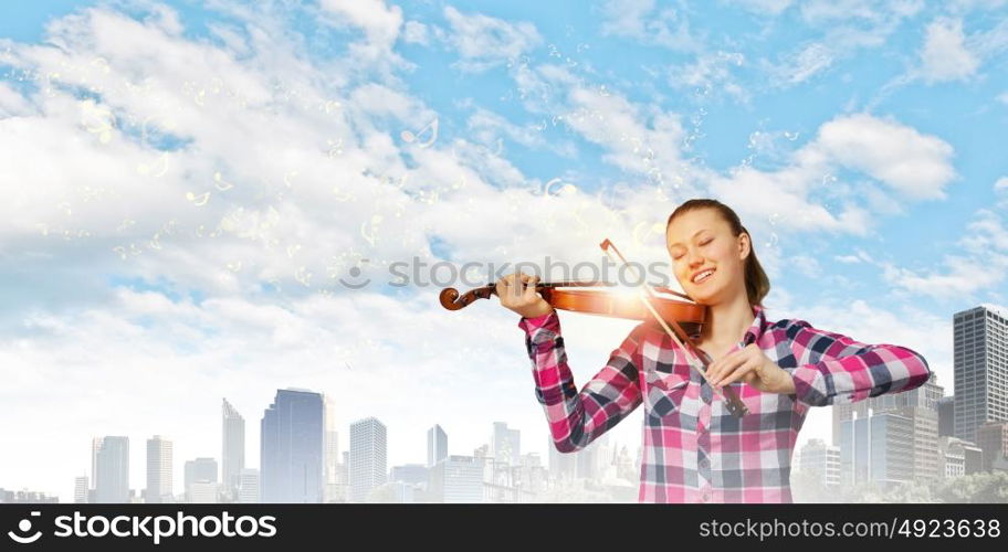 Girl with violin. Young pretty girl in casual playing violin