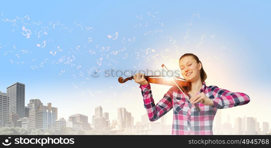 Girl with violin. Young pretty girl in casual playing violin