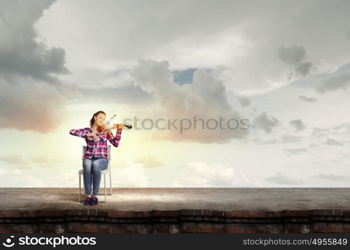 Girl with violin. Young pretty girl in casual playing violin