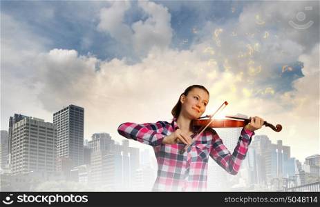 Girl with violin. Young pretty girl in casual playing violin